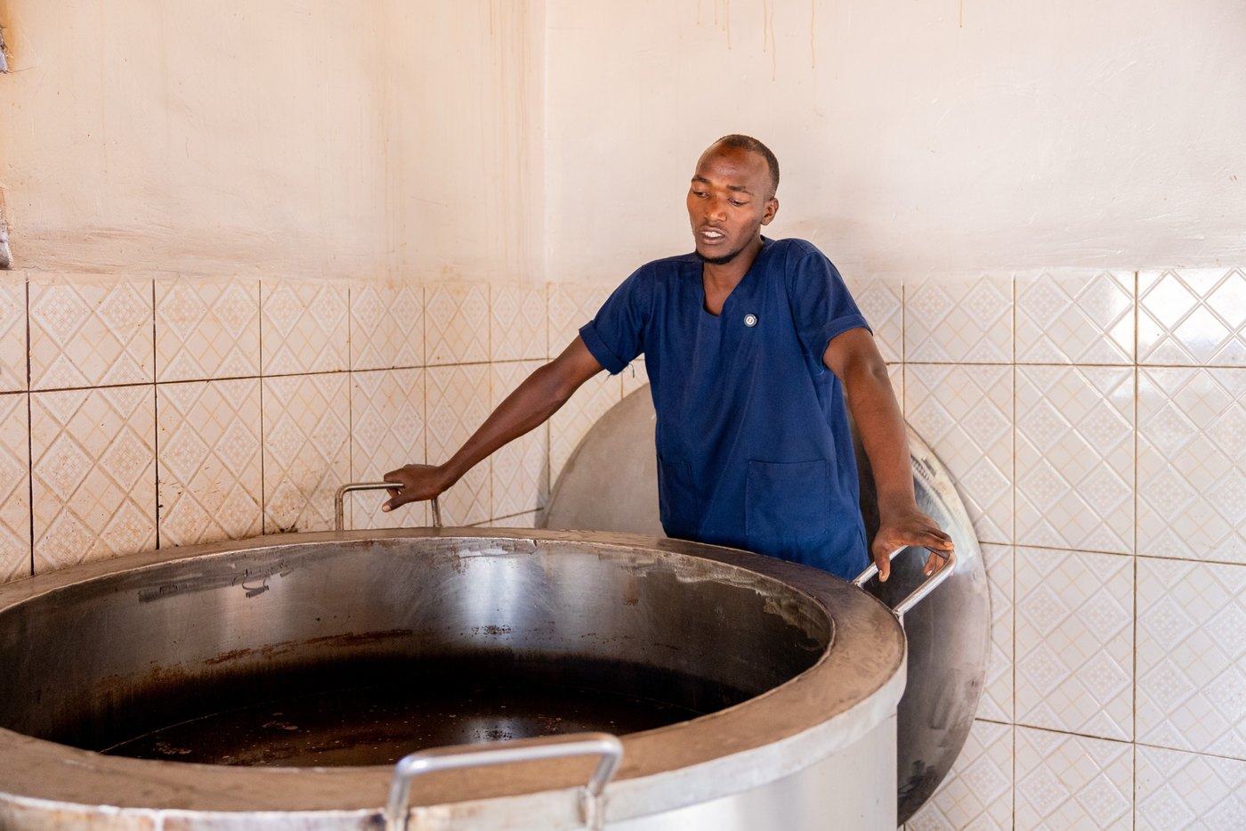A cook beside an energy-saving stove