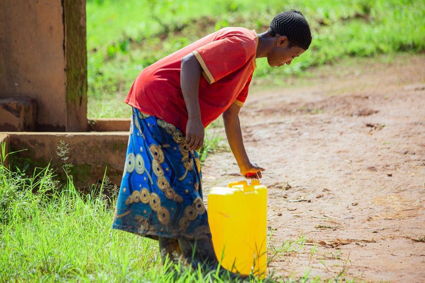 A neighbour lifts a full jerrycan