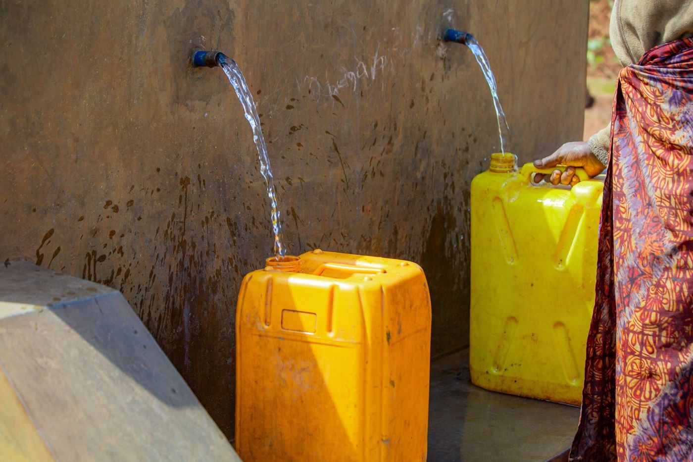 Two taps, two jerrycans
